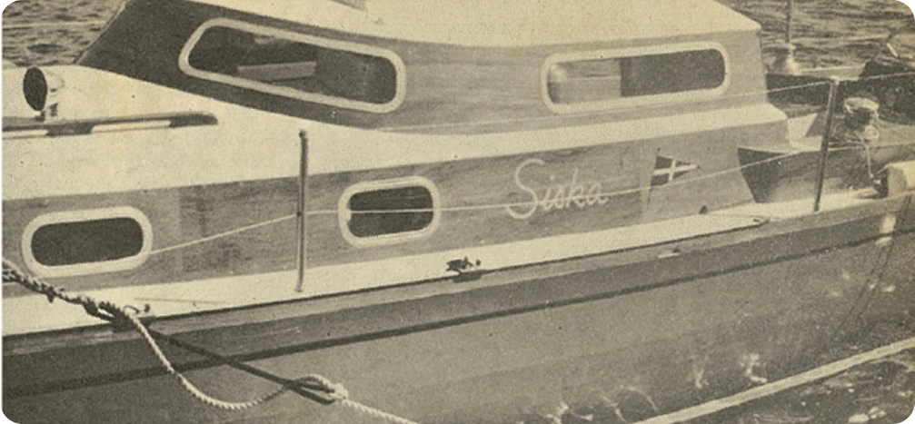 A vintage photo of a small wooden boat named Suke, moored on the water. With its rectangular windows and curved cabin roof, it echoes the elegant design of Classic Sailing Yachts such as Schärenkreuzer.